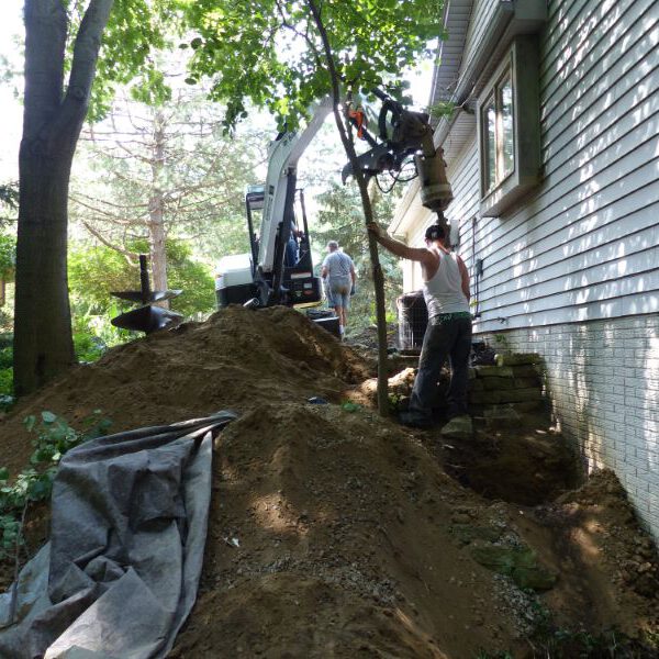 workers digging beside the house